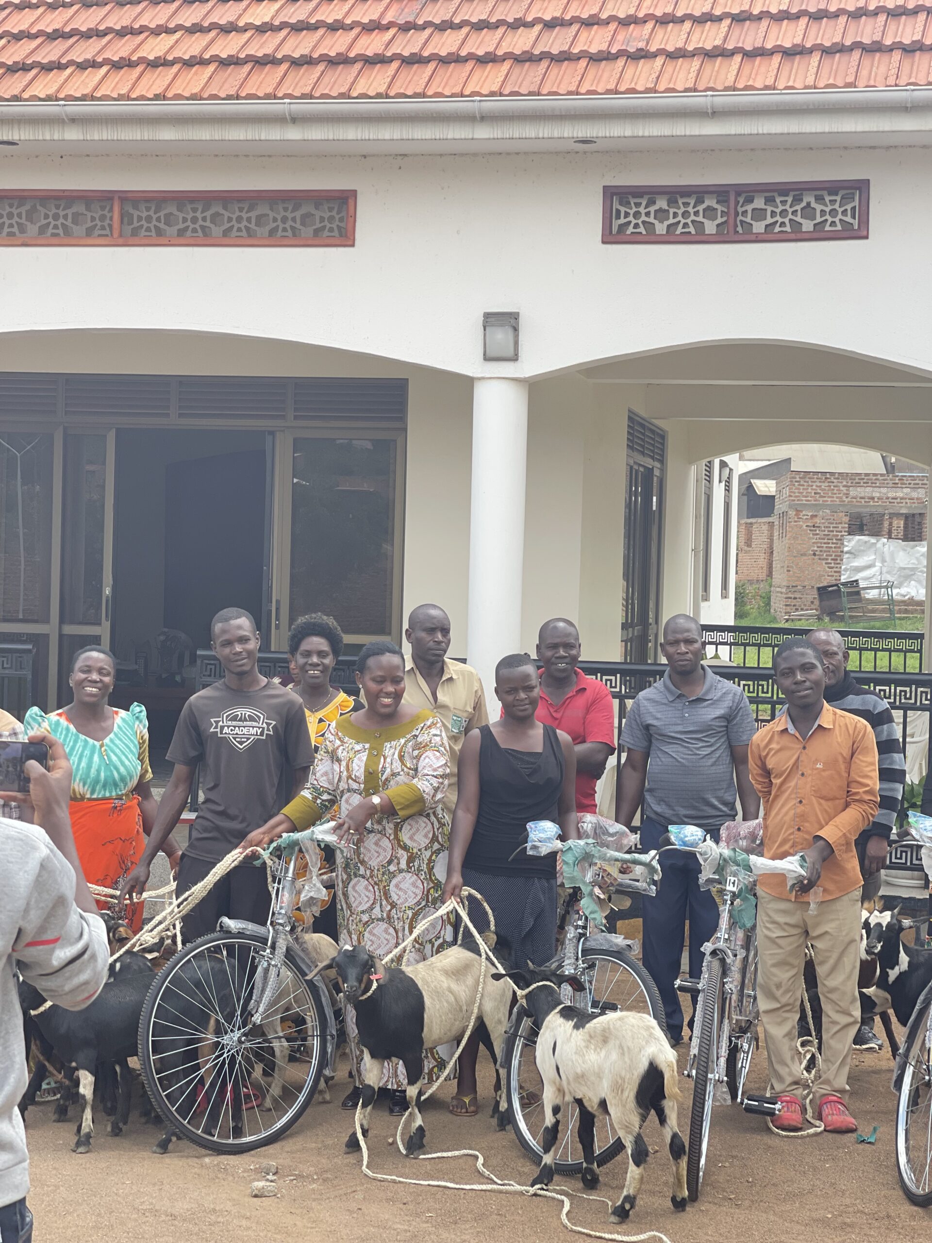 Mary Begumisa donating goats & bicycles to underprivileged students 